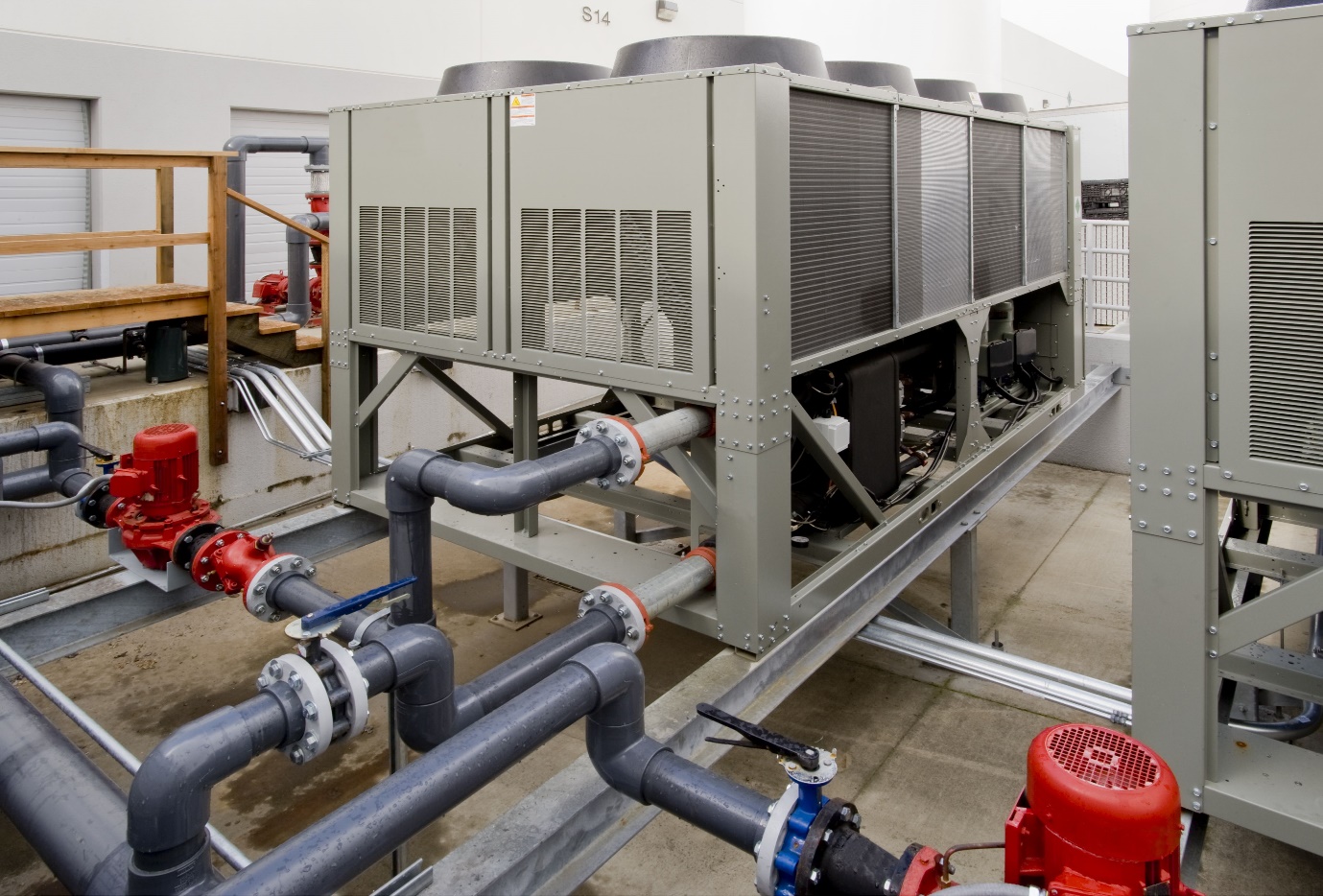 Air-cooled chiller installation with connected pipework and circulation pumps