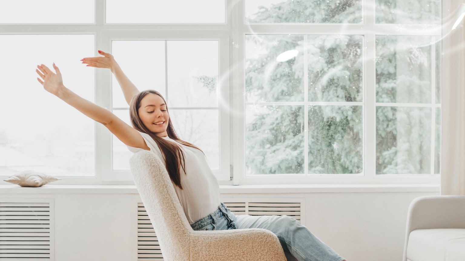 Woman relaxing in a bright room beside large windows
